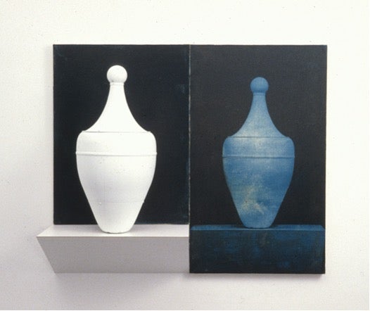 Ceramics displayed on black backround, white on left and teal on right
