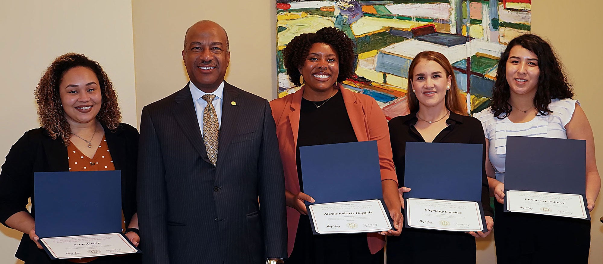 4 award recipients with certificates, posing with Chancellor Gary S. May, UC Davis