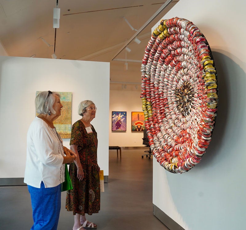Women visitors viewing basket artwork