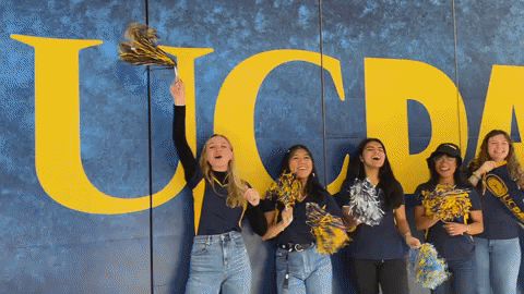 celebrating Aggies in front of the UC Davis logo!