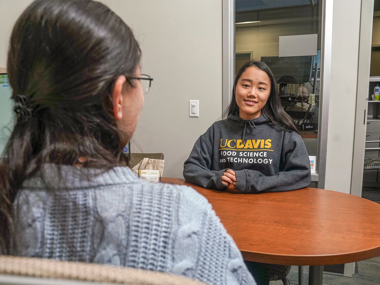 A UC Davis student listens to an academic advisor.