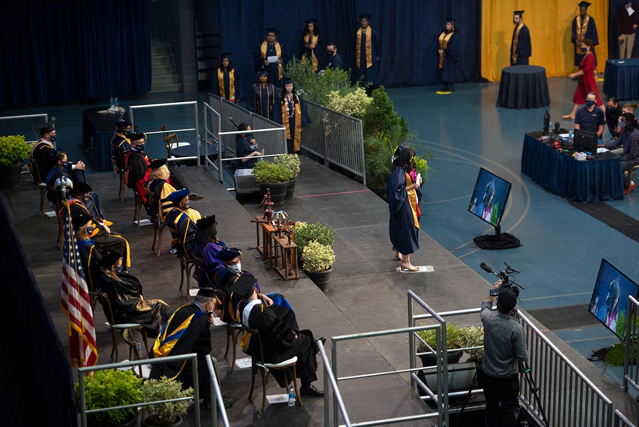 Students line up to walk across the stage inside the Pavilion.