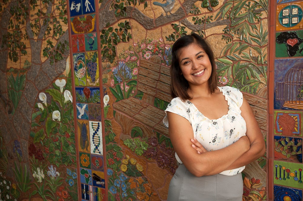 Valeria Garcia, a community development graduate studies major, stands in front of a mural in the Student Community Center on Friday August 8, 2014 at UC Davis.