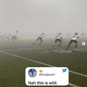 Football players playing in fog, with tweet superimposed. Tweet reads: "Nah this is wild"