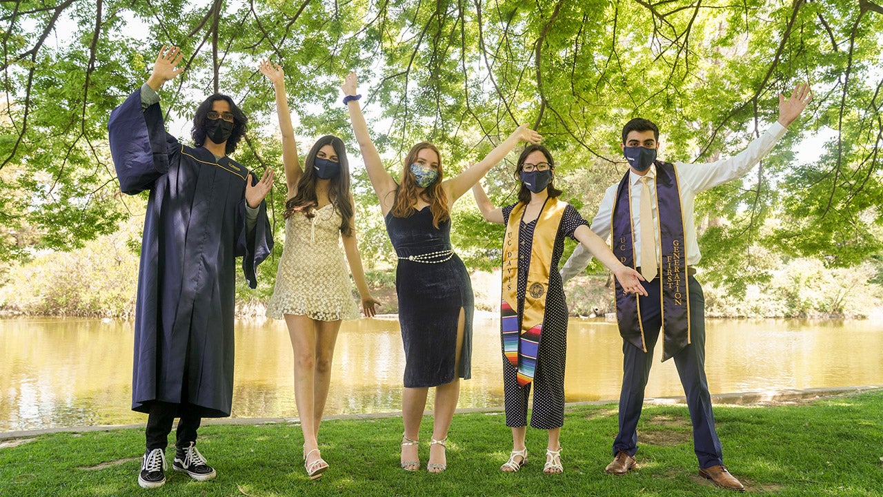 Students wearing face coverings celebrate near Lake Spafford.