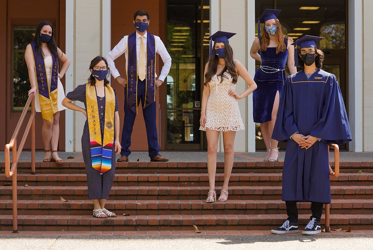 Students in graduation regalia or formal clothing wear face coverings.