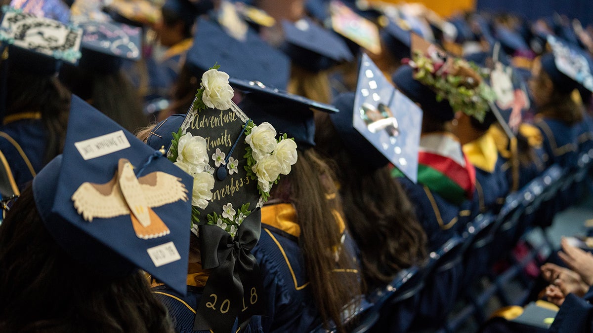 students with grad cap decorated for commencement