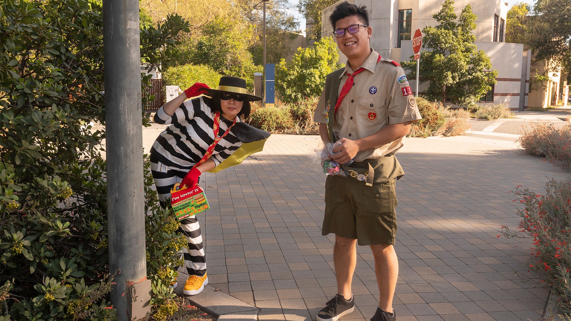 People dressed in costume: The Hamburglar and a Boy Scout
