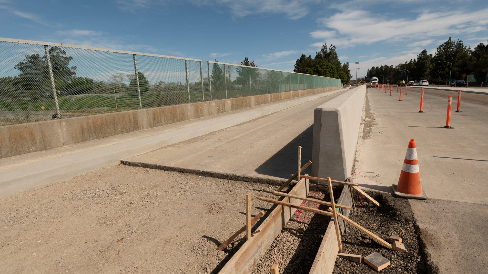 Construction: cocrete barrier separating cycle track (bike lane) and traffic lane