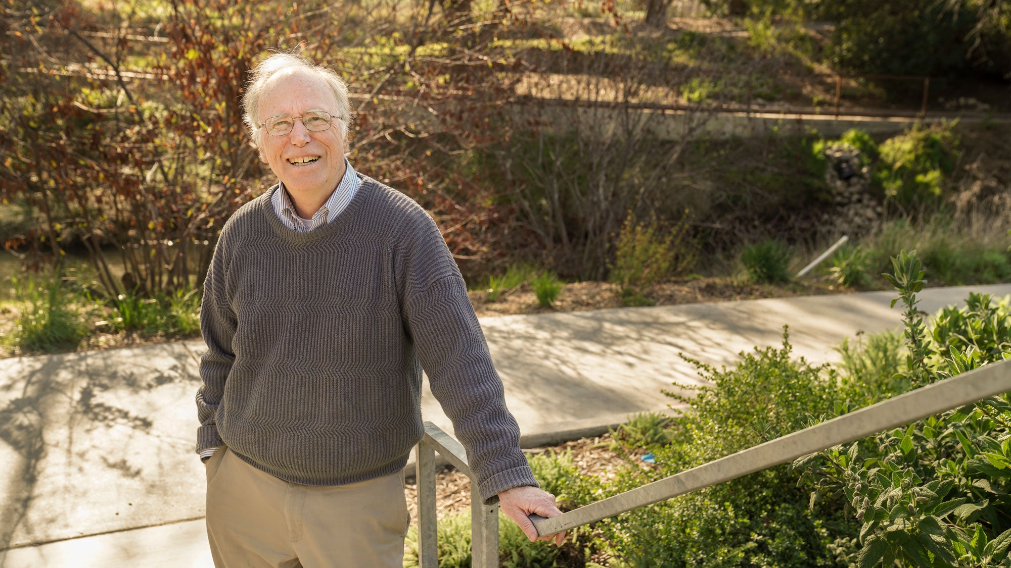 Jay Lund, UC Davis faculty, poses on walkway with Arboretum Waterway behind him
