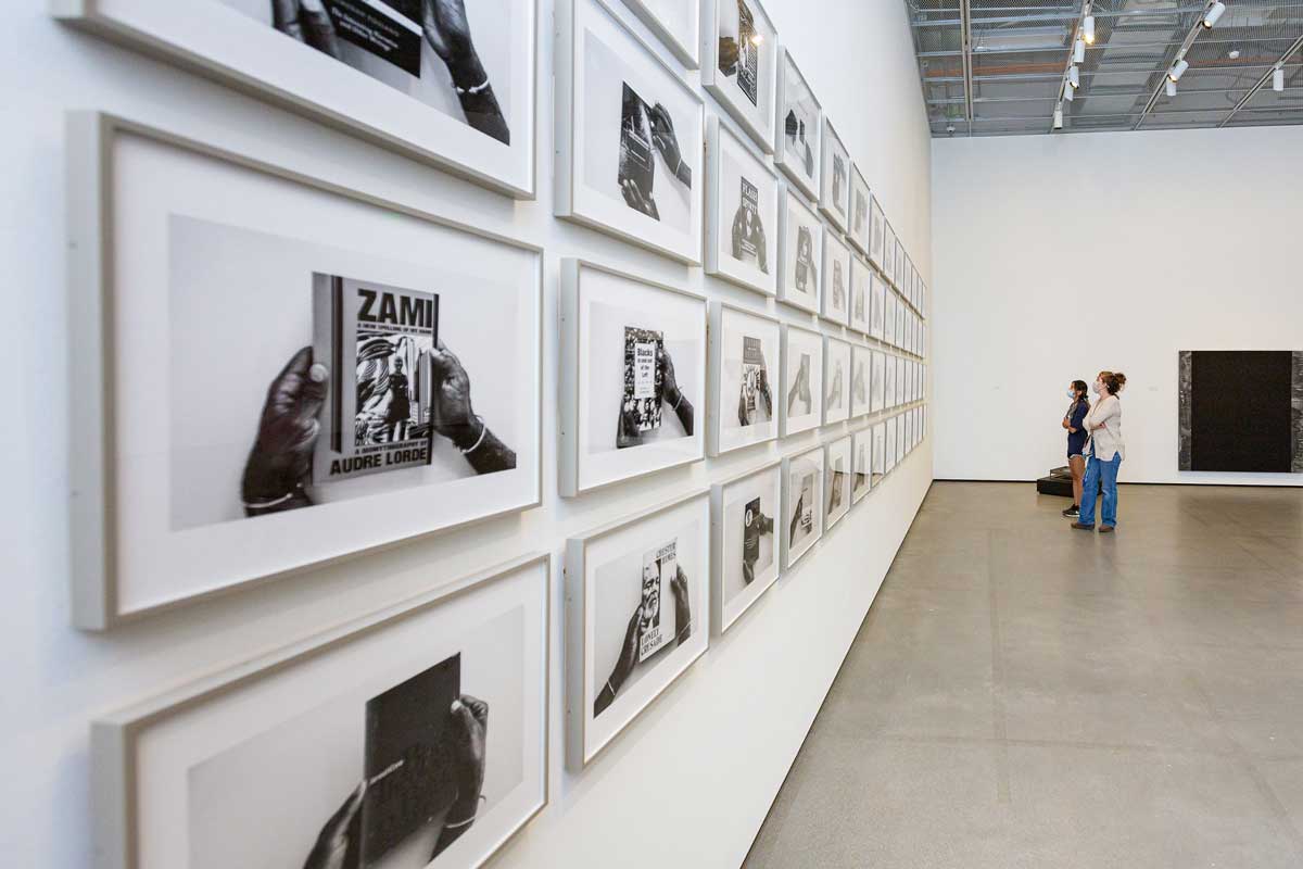 Students view Arnold Kemp's exhibit of black-and-white art