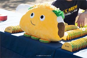 Stuffed taco sits on pile of UC Davis Law-branded tacos