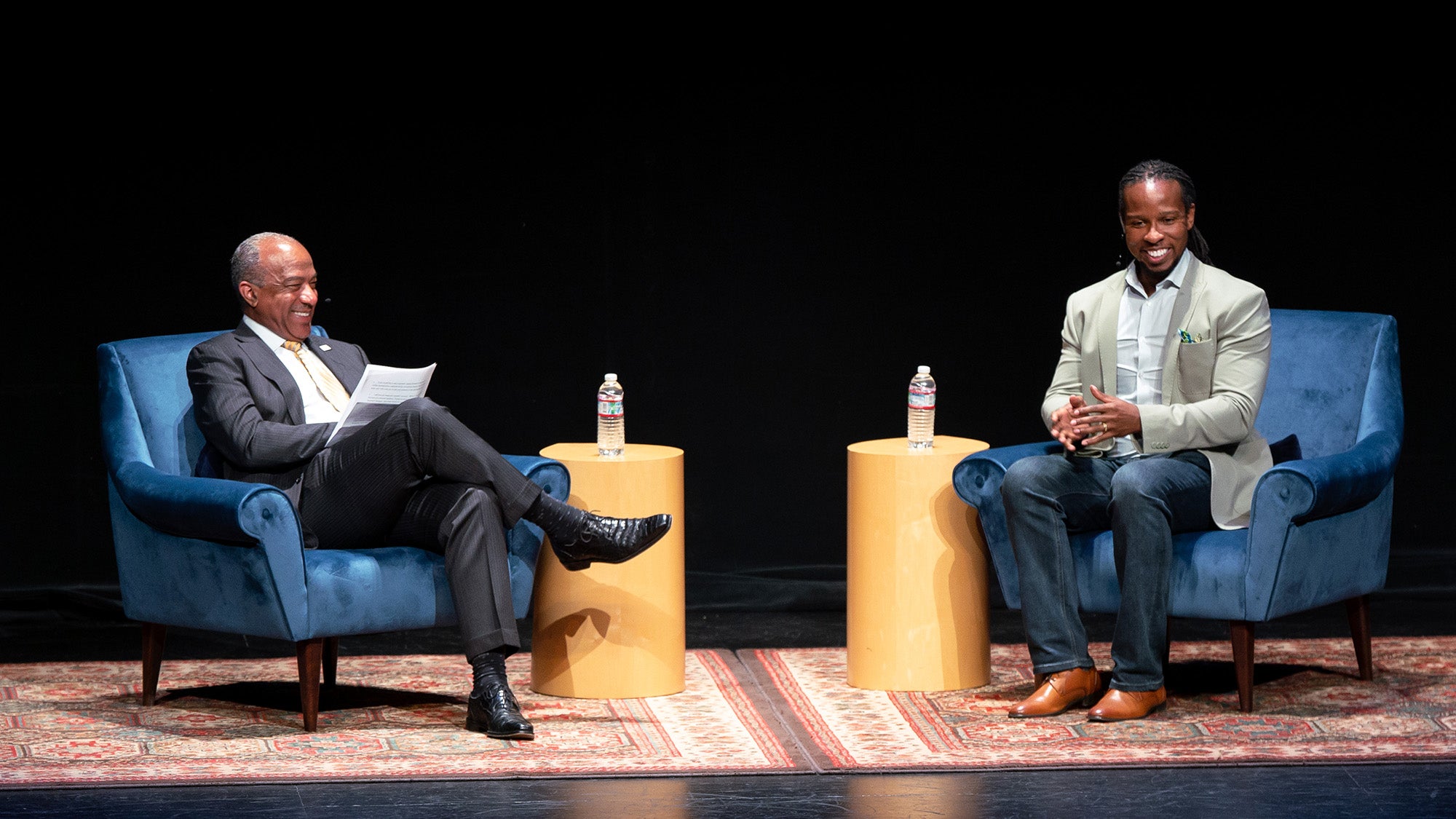 Chancellor Gary S. May and Ibram X Kendi share a laugh on stage.