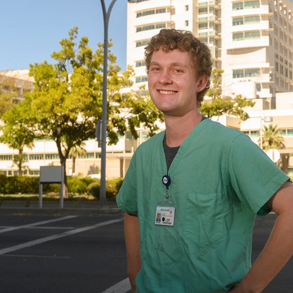 A medical student poses outside of the UC Davis medical center