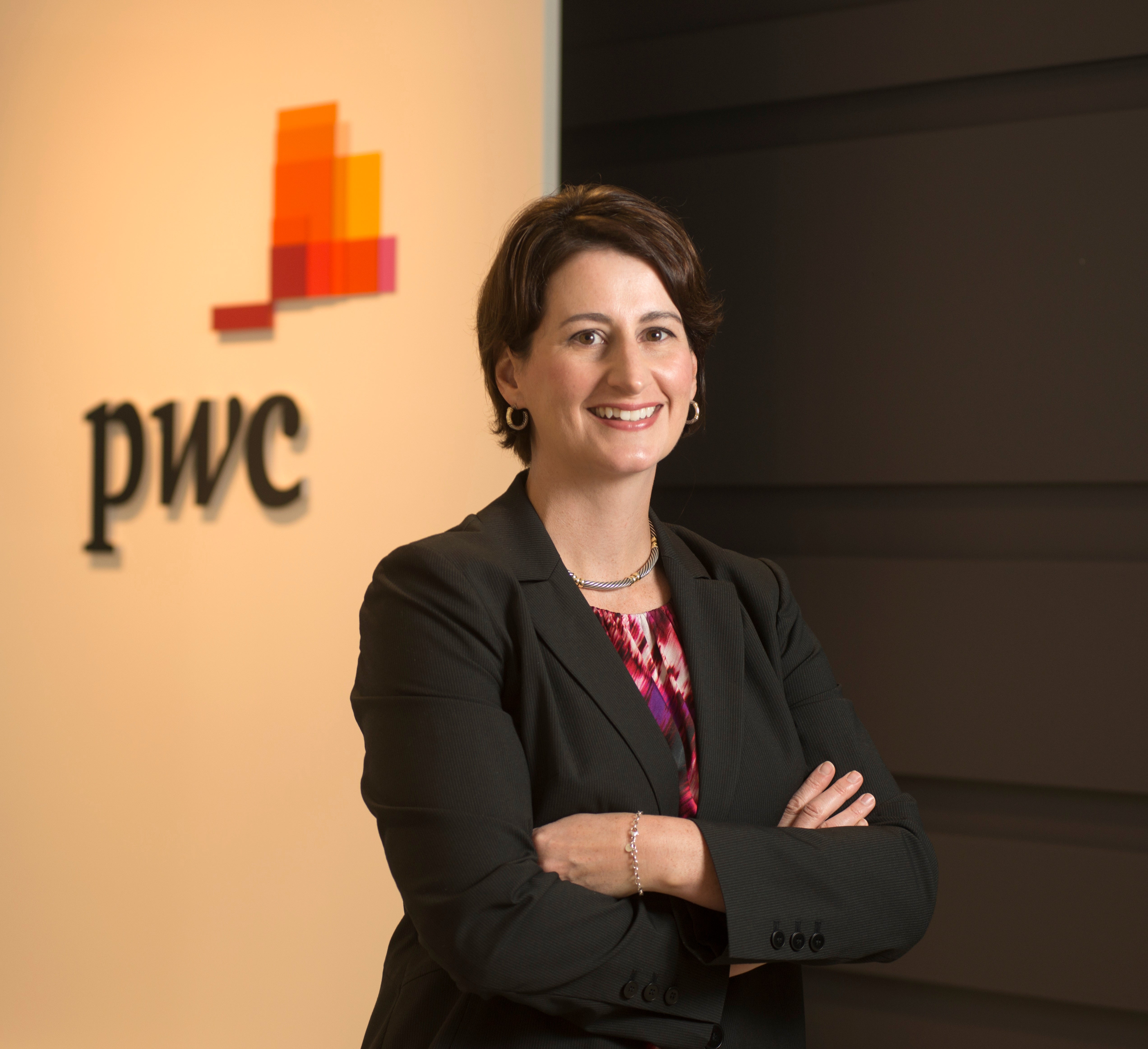 Headshot of woman with her arms crossed