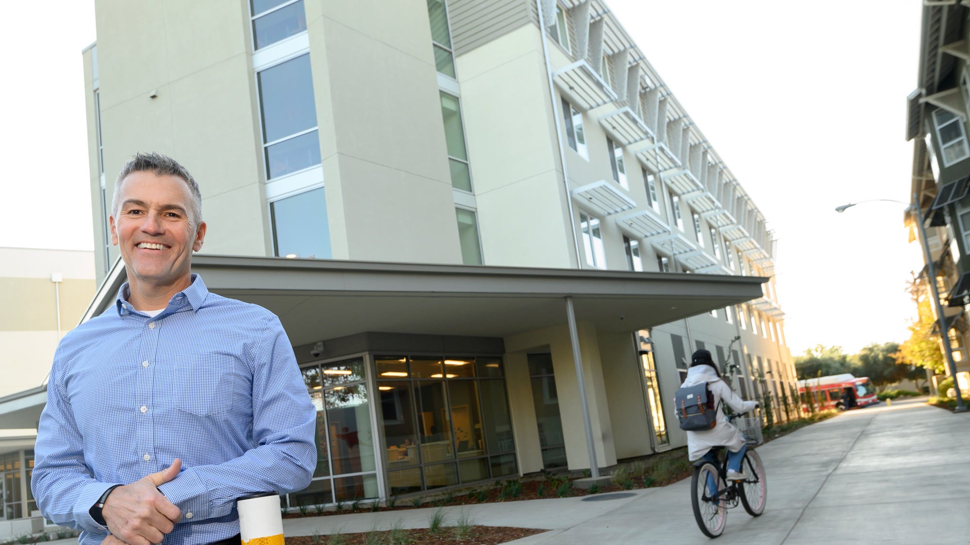 Mike Sheehan, UC Davis administrator, outside new, four-story residence hall