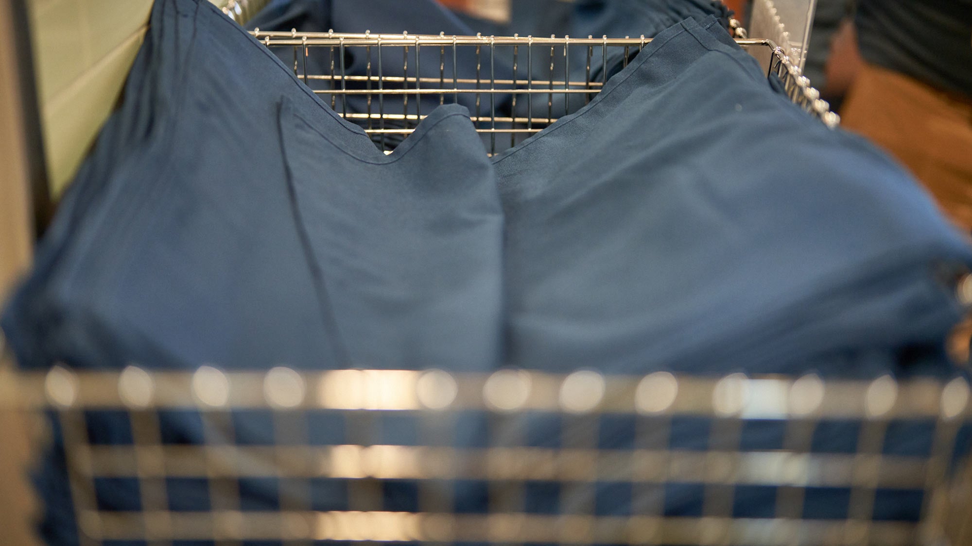 Blue linen napkins, folded, in basket