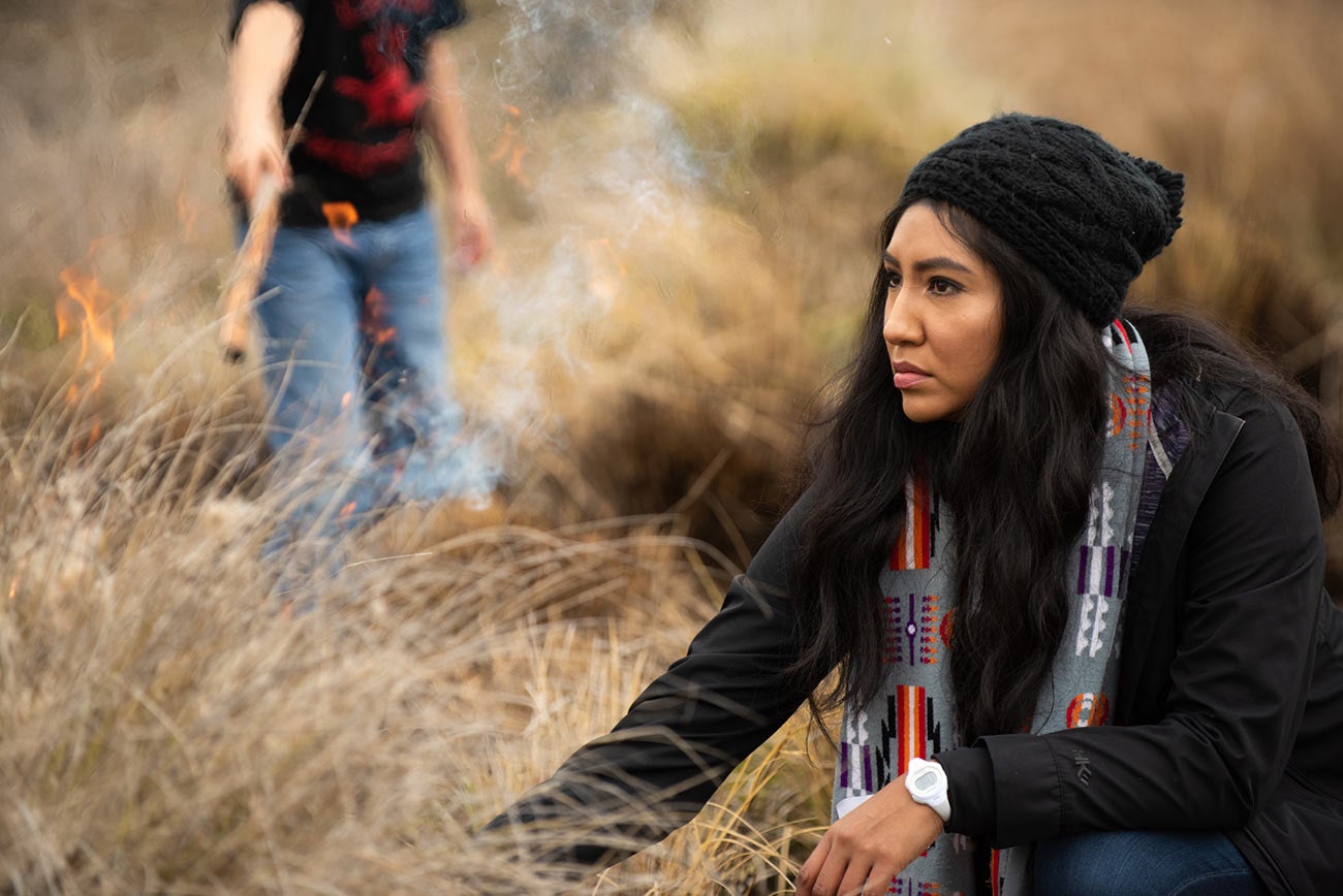 Melinda Adams lights a field of Deergrass on fire