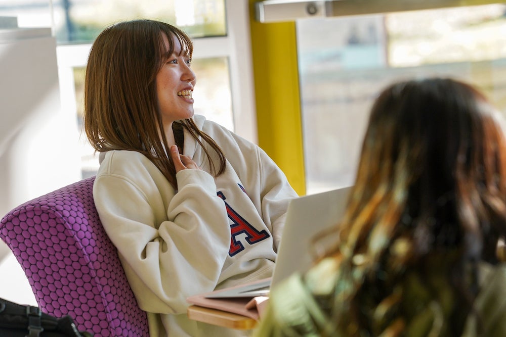 A student smiles at the International Center at UC Davis