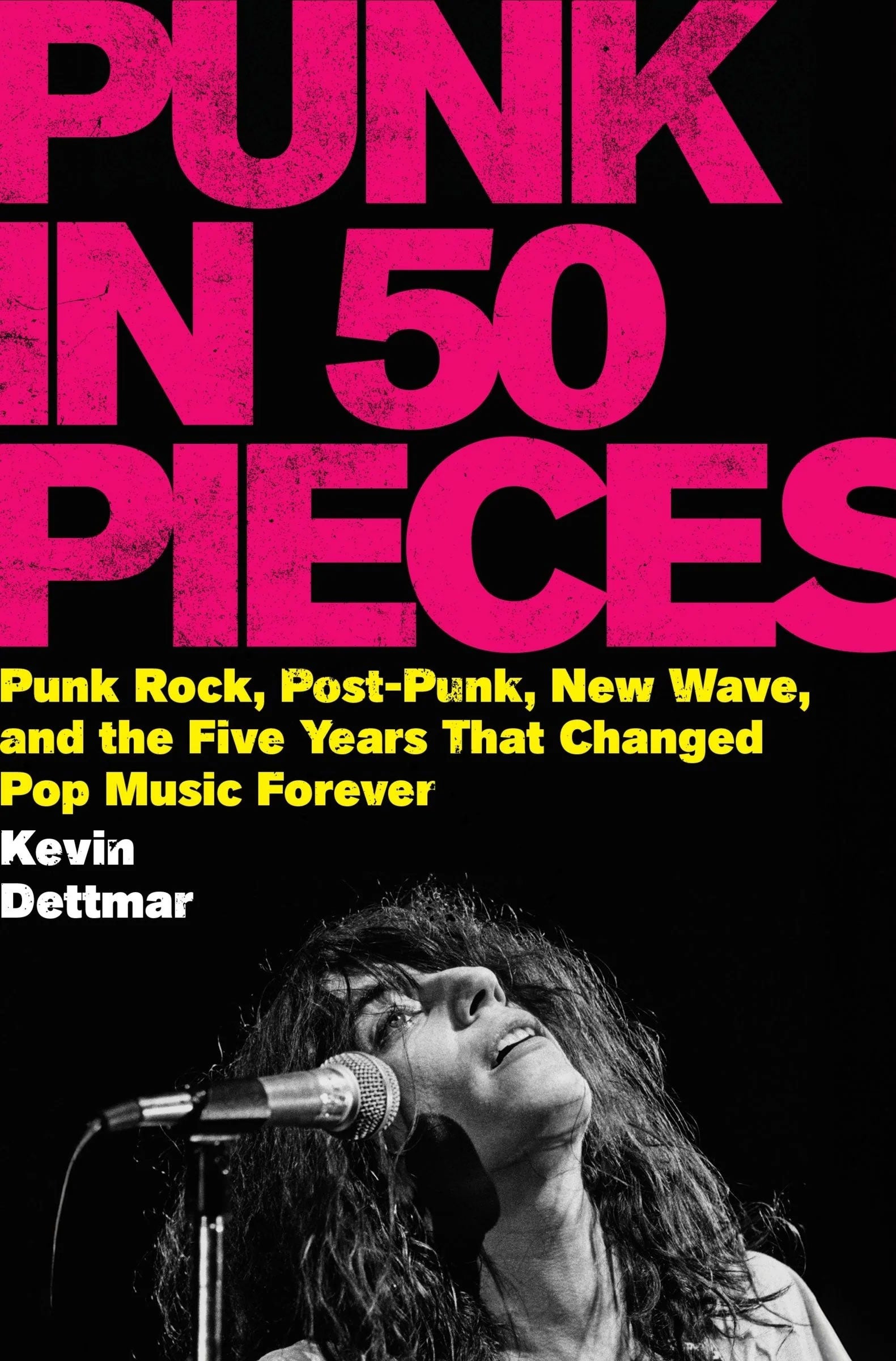 Book cover: bold pink 'PUNK IN 50 PIECES' on black; B/W singer photograph at microphone
