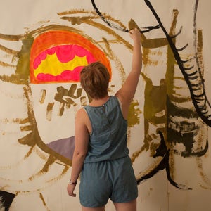 A student working on a painting
