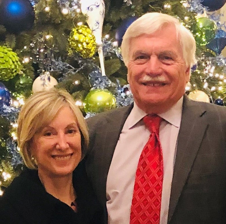 Robert and Carolyn Caligiuri, posed in front of Christmas tree