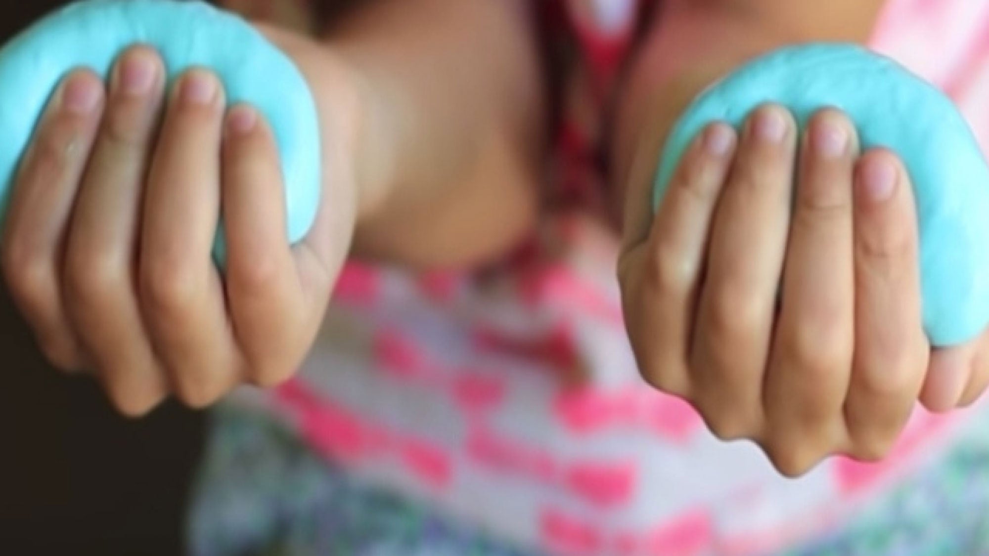 Silly Putty, in two hands of child
