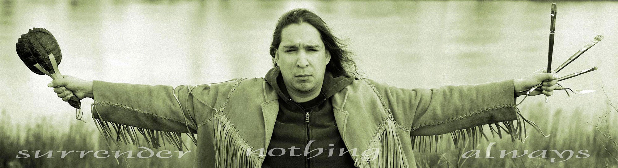 Sepia-toned portrait of individual, arms spread, in front of body of water