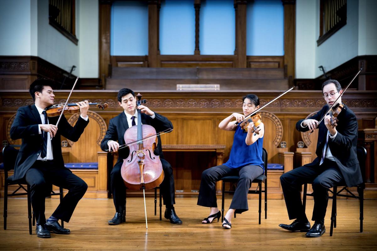 Members of a quartet play on stage