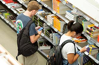 Students browsing in textbook aisle.