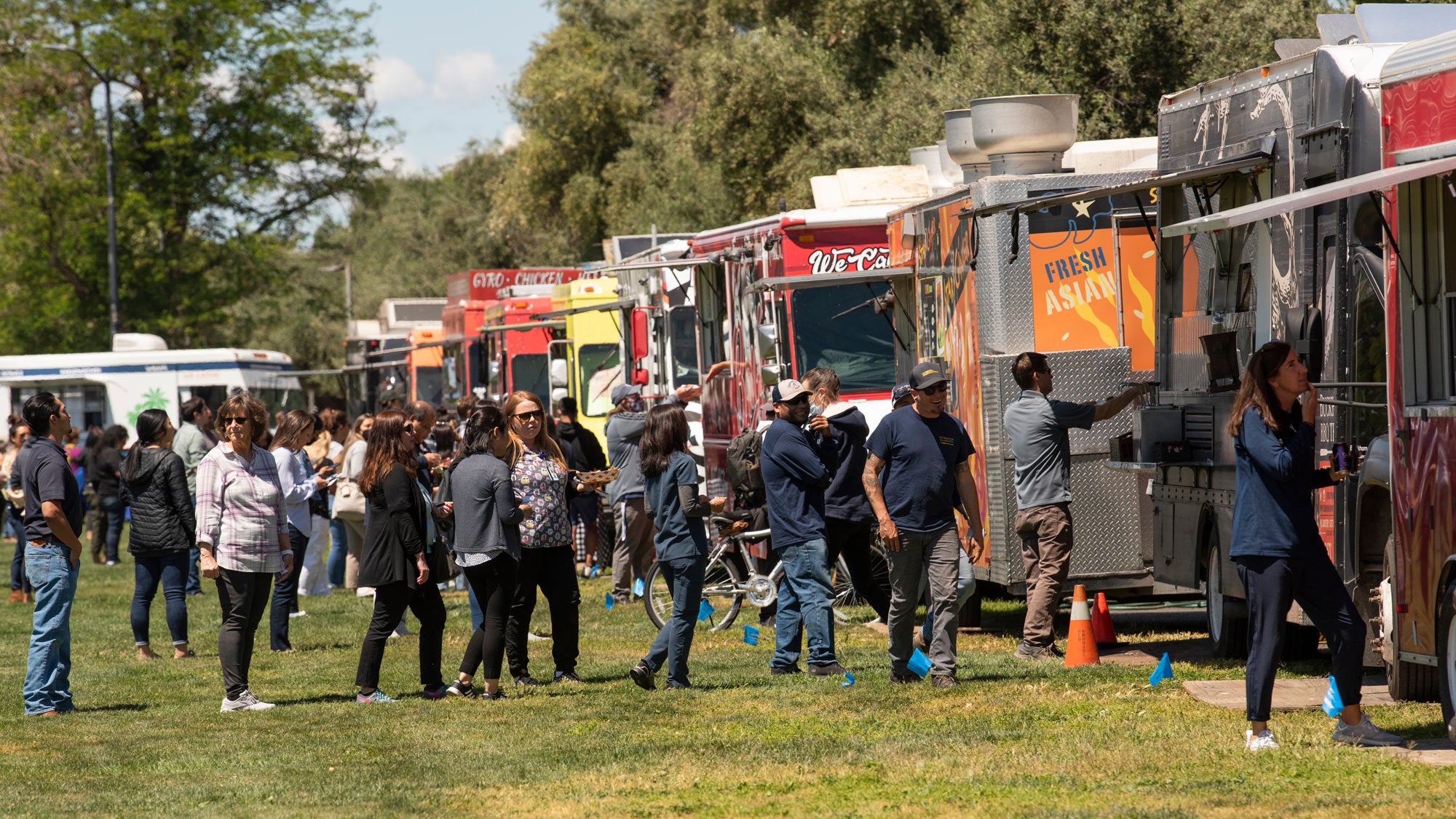 Food trucks lined up on Russell Field, people waiting in lines