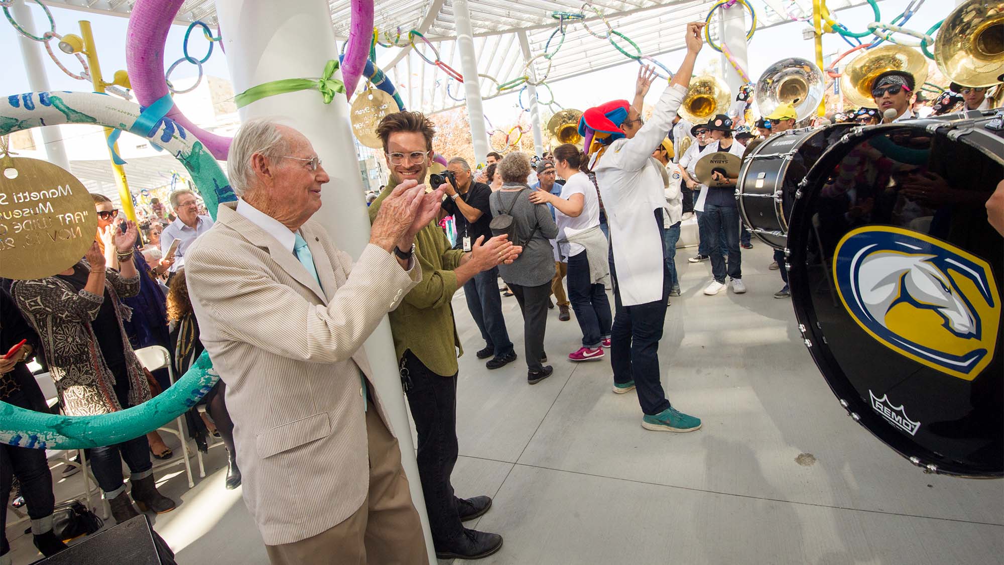 Wayne Thiebaud applauds as the marching band plays at the Jan Shrem and Maria Manetti Shrem Museum of Art grand opening.