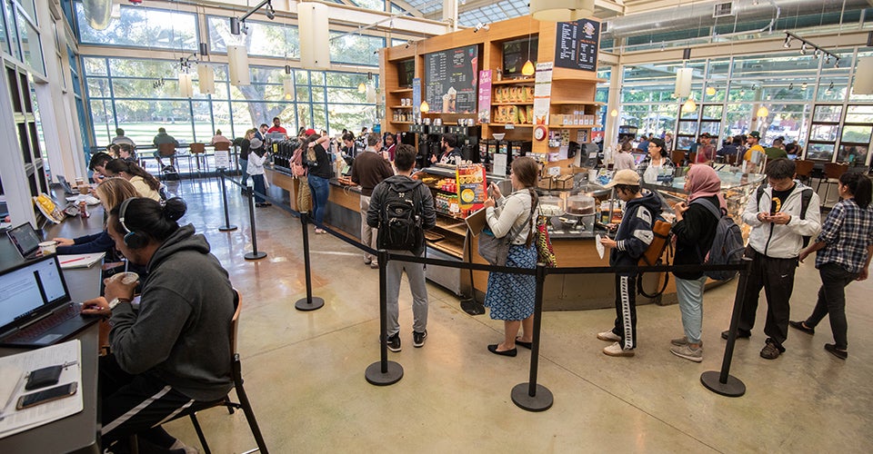 a line of students wait for coffee at the CoHo Coffee House