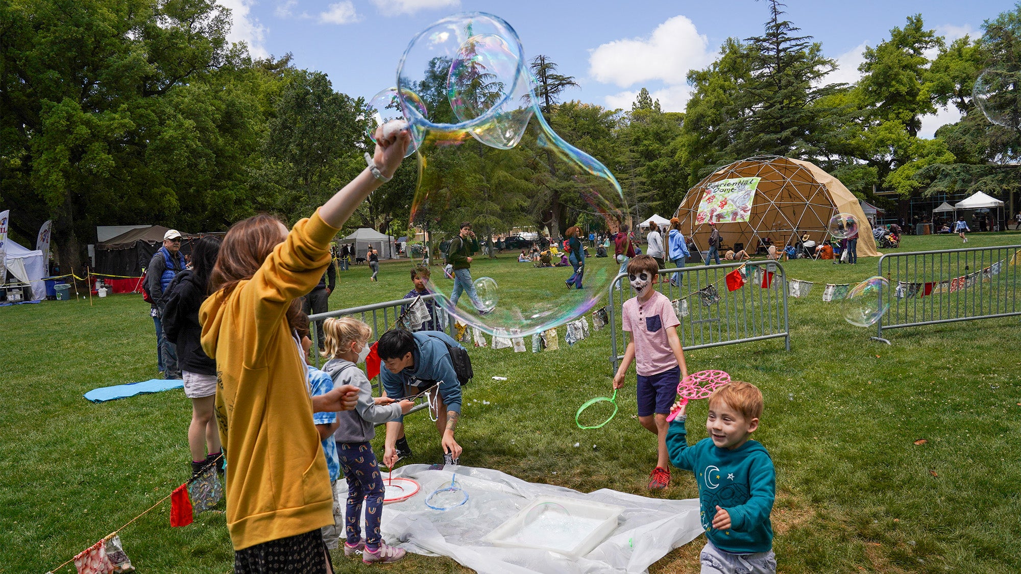 Kids watch a giant bubble on the Quad