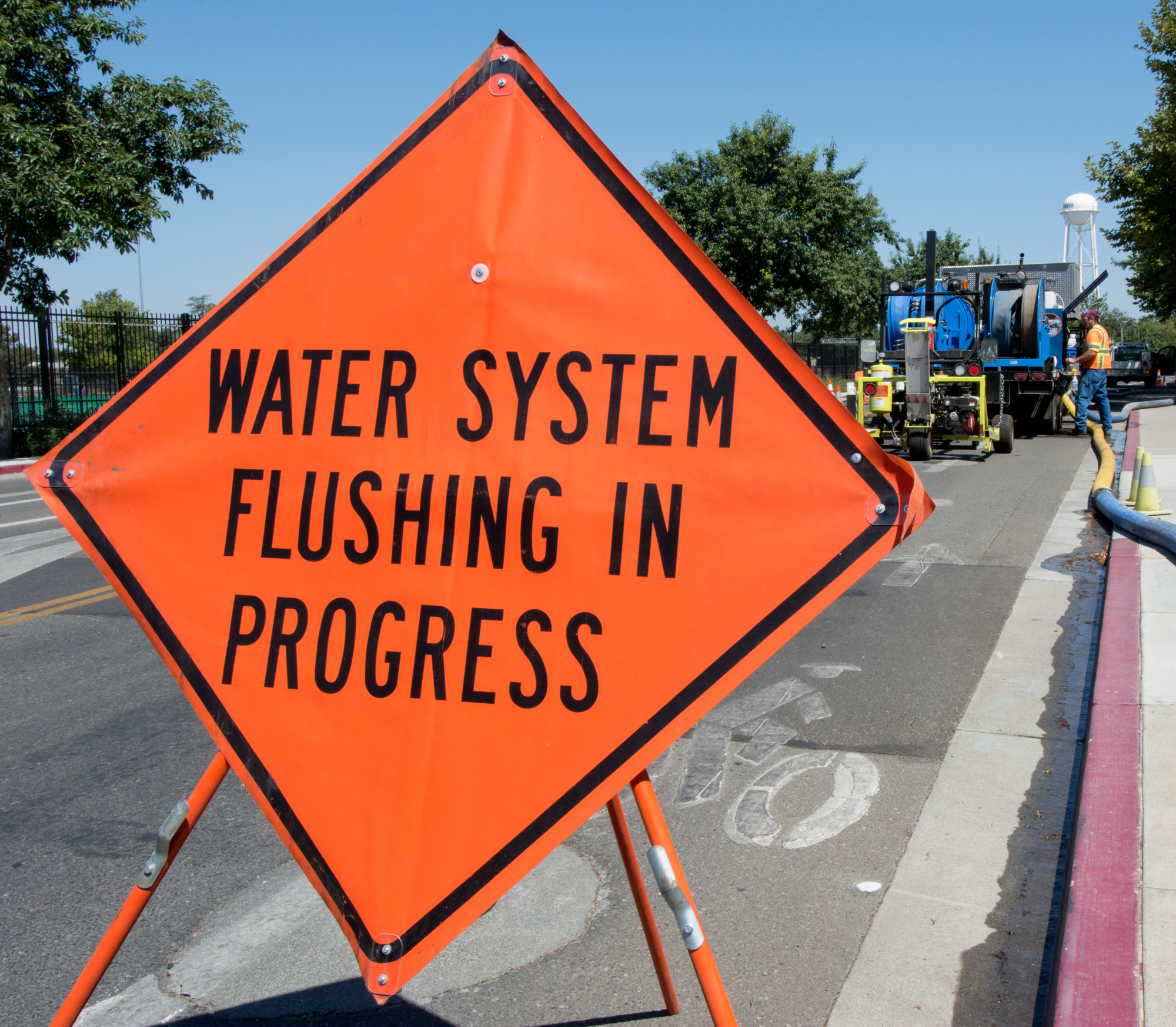 A sign reads "water system flushing in process."