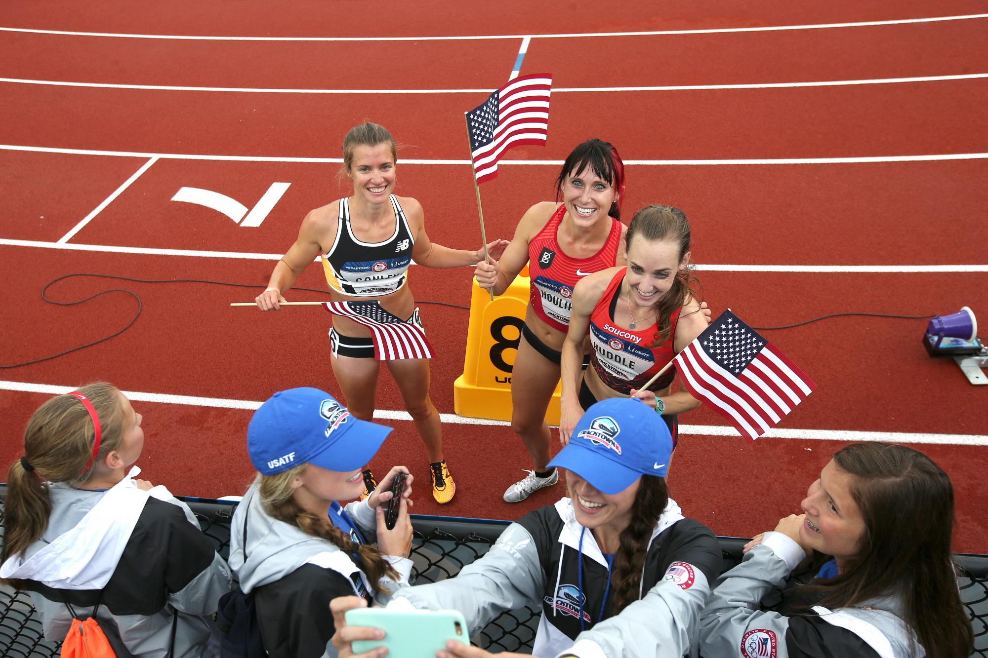  Kim Conley holds U,S. flag after trials.