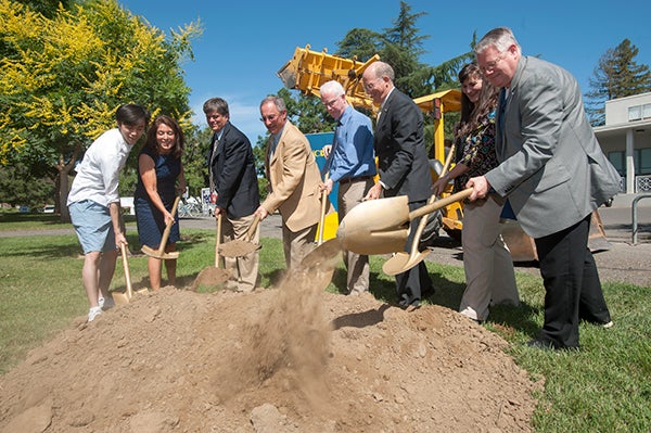 Students, faculty and staff break ground on the lecture hall.
