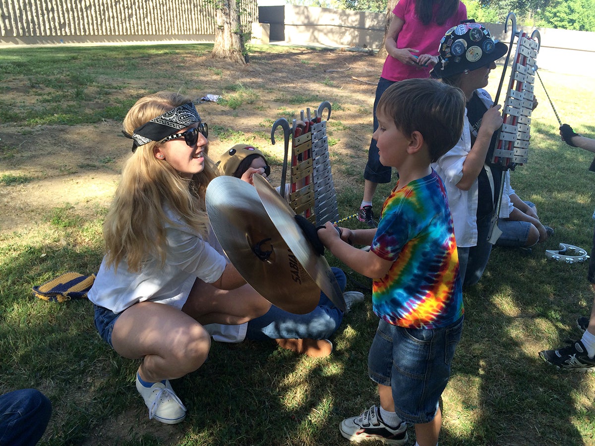 A child plays with cymbals at UC Davis.