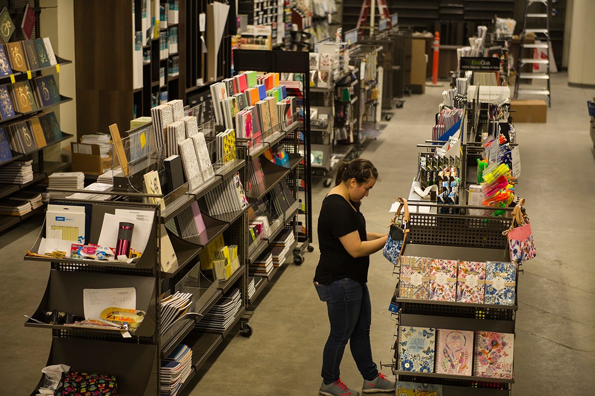 An employee works in the textbooks section of the Campus Store at UC Davis.