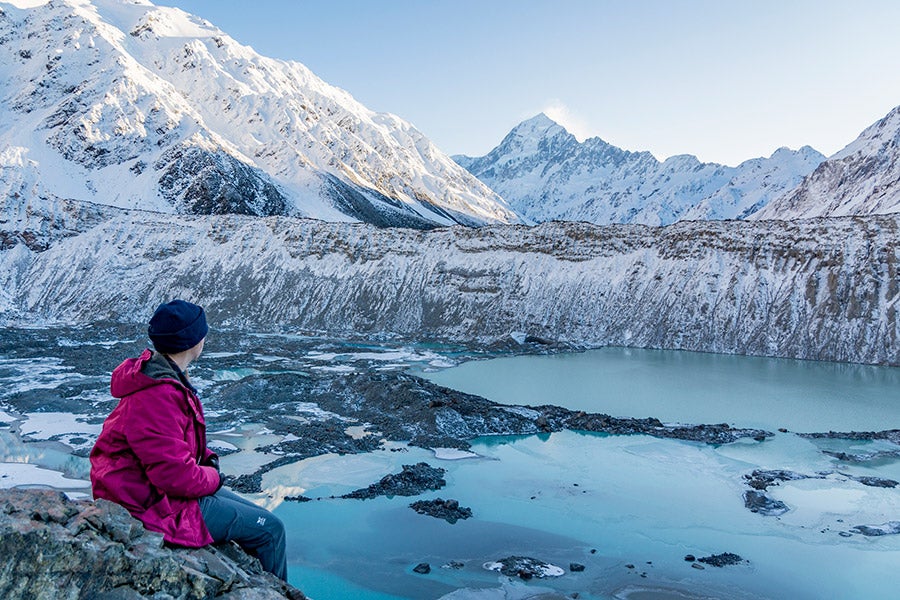 A student looks out on a snowy Mt. Cook in New Zealand.