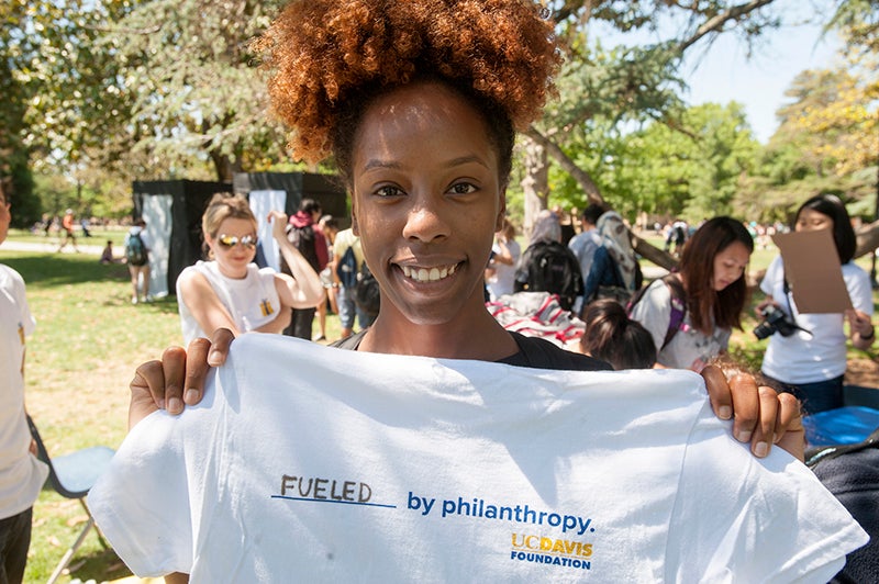 Photo of Charrisha Hillery with a T-shirt that reads "fueled by philanthropy."