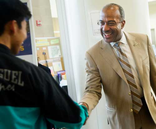 Gary May shakes a student's hand.