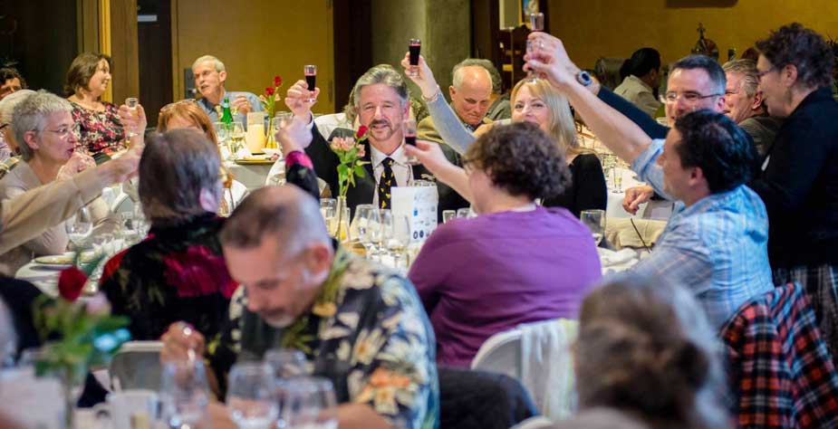  People toasting at banquet.