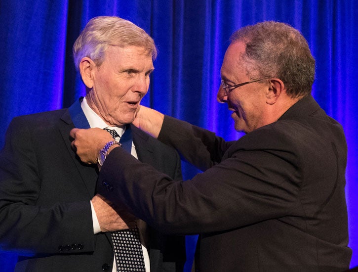 Ralh Hexter places medal on Bruce Edwards.