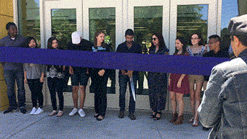 ASUCD President Josh Dalavai cuts a ceremonial ribbon to reopen the Memorial Union.