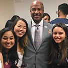 Gary May poses with students