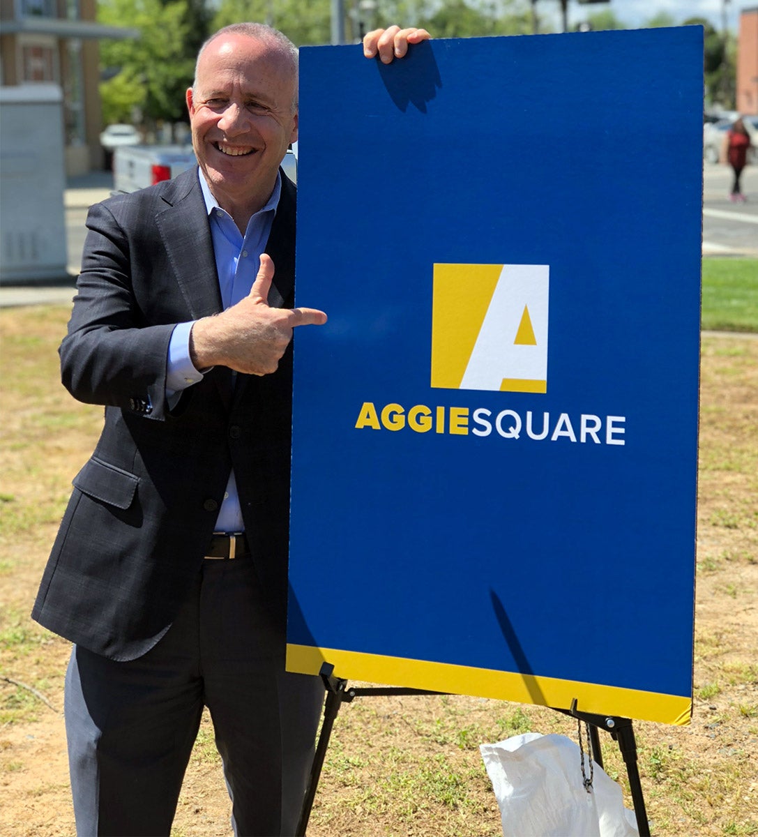 Sacramento Mayor Darrell Steinberg poses with Aggie Square sign.