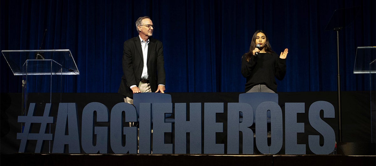 Professor Alan Bennett and recent graduate Rosy Maria Martinez on stage at the Aggie Heroes welcome event.