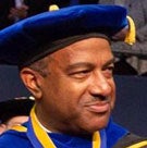 Chancellor Gary S. May mugshot, in cap and gown