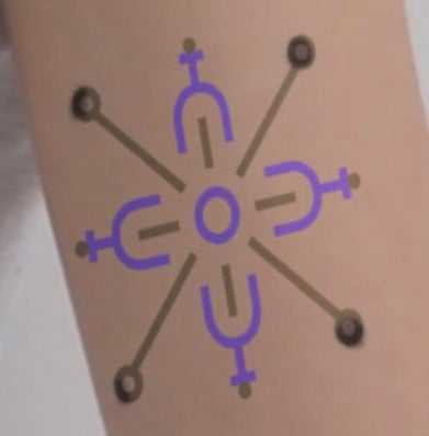 Biomedical tattoo on arm (screen shot)